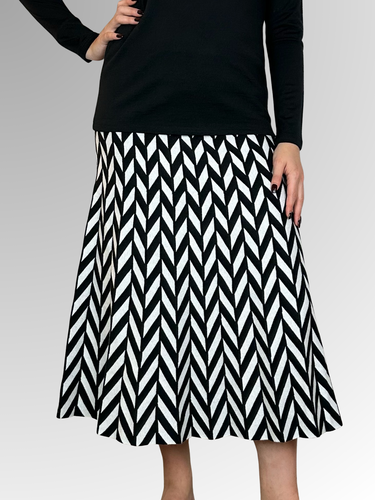 Indulge in luxury and make a statement with our Domino Knit Skirt. The bold A-Line design is both sophisticated and cozy, perfect for the cooler seasons. Crafted from a blend of rayon, wool and elastane, this mid length skirt offers comfort and style. Pair with boots for an effortlessly chic autumn/winter look.