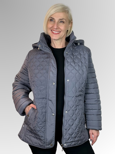 Upgrade your winter wardrobe with our Pewter Blistered Puffer Jacket by Jillian. This sleek and chic puffer features a cozy fur lining, ribbed accents for added style, and includes zippered pockets and a detachable hood for practicality and warmth. Crafted from polyester, it offers easy maintenance and care.