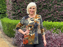 Elevate your everyday style with the Orientique Dagomba Patch Top - a rich tapestry of colour and texture. This playful piece combines mixed fabrics in a spliced design, creating visual interest from every angle. Detailed button trim and decorative stitching add character and charm, while the soft rayon and spandex blend ensures comfort and movement. Perfect for those who love bold, artistic fashion that stands out.