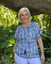 Beat the heat in style with the gorgeous Buzios Tassel Top from Orientique! Made from soft organic cotton, this charming piece features a soft ruffled neckline, tasseled strings and short sleeves that frame the shoulders perfectly. It's the ultimate combo of comfort and fashion that'll keep you looking fabulous and feeling cool all summer long.