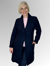 Wrap yourself in luxury with our Boiled Wool Navy Pea Coat. Certified with the prestigious Woolmark label, this modern, soft boiled wool coat is both warm and stylish. Featuring a contemporary take on the classic coat, it's the perfect statement piece for any fashion-forward wardrobe. Upgrade your look and embrace true quality.