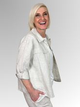 Meet the Button-Through Linen Resort Jacket in Natural, your new go-to layer for effortless, everyday style.&nbsp;Crafted from 100% pure linen, this lightweight jacket combines a relaxed, breezy silhouette with tailored details. It features a classic shirt collar and a full button-down front, making it easy to wear open over a tank or closed as a structured shirt. Designed for ultimate versatility, the sleeves come with built-in tab-and-button cuffs so you can easily roll them up on warmer days. 