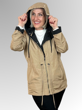 Get two looks in one with our Courtney Reversible Jacket. Flip between black and rich camel, with contrasting cuffs that beautifully highlight the colour change. A detachable hood, practical pockets and zip-and-stud front closure give you complete control over the elements, while an adjustable drawstring waist delivers a custom fit. Made from durable polyester, this versatile jacket handles unpredictable weather with ease making it ideal for travellers and anyone who loves flexible wardrobe options.