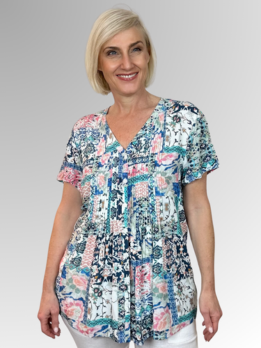 Enjoy warm days with the Mary Pintuck Shirt by Callan, made from soft, breathable rayon that feels light and airy. Featuring a fun V-neck and delicate pintuck detailing on both front and back, this relaxed A-line shirt offers an easy, flowing fit. With its subtle patchwork print, it’s the perfect playful piece to brighten up your casual wardrobe.