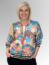 Bring playful style to your wardrobe with Orientique’s Picnic Digital Print Zip Jacket. Crafted from lightweight rayon with a luxurious satin finish, it offers effortless comfort in a relaxed bomber silhouette. The striking digital print is perfectly elevated by eye-catching black and gold lurex bands at the cuffs and hem. Complete with a breezy zip front, it is the perfect fashion-forward layer to easily elevate any everyday outfit.