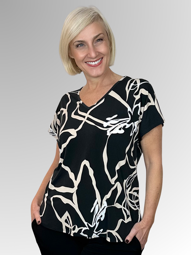 Experience effortless style with the Lotus Breeze Top by Philosophy. Its relaxed fit combined with a chic black, beige and white print offers a versatile look. Crafted from a soft polyester and elastane blend, this top ensures comfort and easy care, making it perfect for both busy days and casual outings. Elevate your wardrobe with a piece that blends fashion and practicality seamlessly.