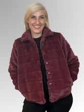 Wrap yourself in effortless sophistication with the beautifully crafted Gigi Faux Fur Jacket. Made from soft, high-quality polyester, it delivers the plush look and feel of real fur while remaining lightweight and easy to wear.&nbsp;The rich, warm-toned claret hue adds depth and sophistication, making it a standout piece for cooler days and evenings.&nbsp;Designed with a structured collar and a flattering cropped silhouette, this jacket combines elegance with modern style. The horizontal panel detailing cre