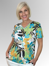 Embrace sunny days in the Aegean Tee by Jillian, featuring a vibrant tropical print that brings fun to your wardrobe. The relaxed fit and flattering V-neck offer effortless style, while the soft polyester-elastane blend ensures comfort all day long. Perfect for a carefree, summery vibe that turns heads wherever you go.