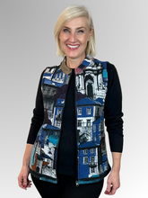 Say hello to the Porto Blue Zip Vest from Orientique. Crafted from cotton, this vest is both sporty and stylish, featuring an eye-catching global architectural print inspired by colourful streetscapes that evoke the spirit of exploration and discovery. Complete with a functional zipper and practical pockets, it's the perfect layering piece to mix and match with your everyday wardrobe. Whether you're dressing up a casual outfit or adding texture to your look, this versatile vest brings a pop of colour and tr