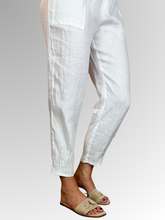 Elevate your warm-weather wardrobe with the Ankle Tuck Linen Resort Pant in White, the ultimate choice for effortless summer style. Perfectly balancing a trendy silhouette with everyday practicality, these pants are crafted from premium, breathable linen designed to keep you cool and comfortable all day long.
