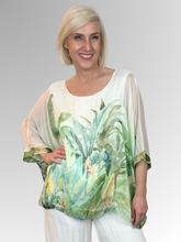 Crafted in Italy from a luxurious blend of viscose and silk, the AE Luxe Verde Serena Top embodies effortless elegance. Its feather-light construction drapes beautifully with distinctive batwing sleeves that fall to a relaxed 3/4 length, creating an understated yet striking silhouette. The soft, stretchy inner lining ensures comfort throughout the day, while the fluid fabric moves with graceful ease. Perfect for holidays and special occasions.