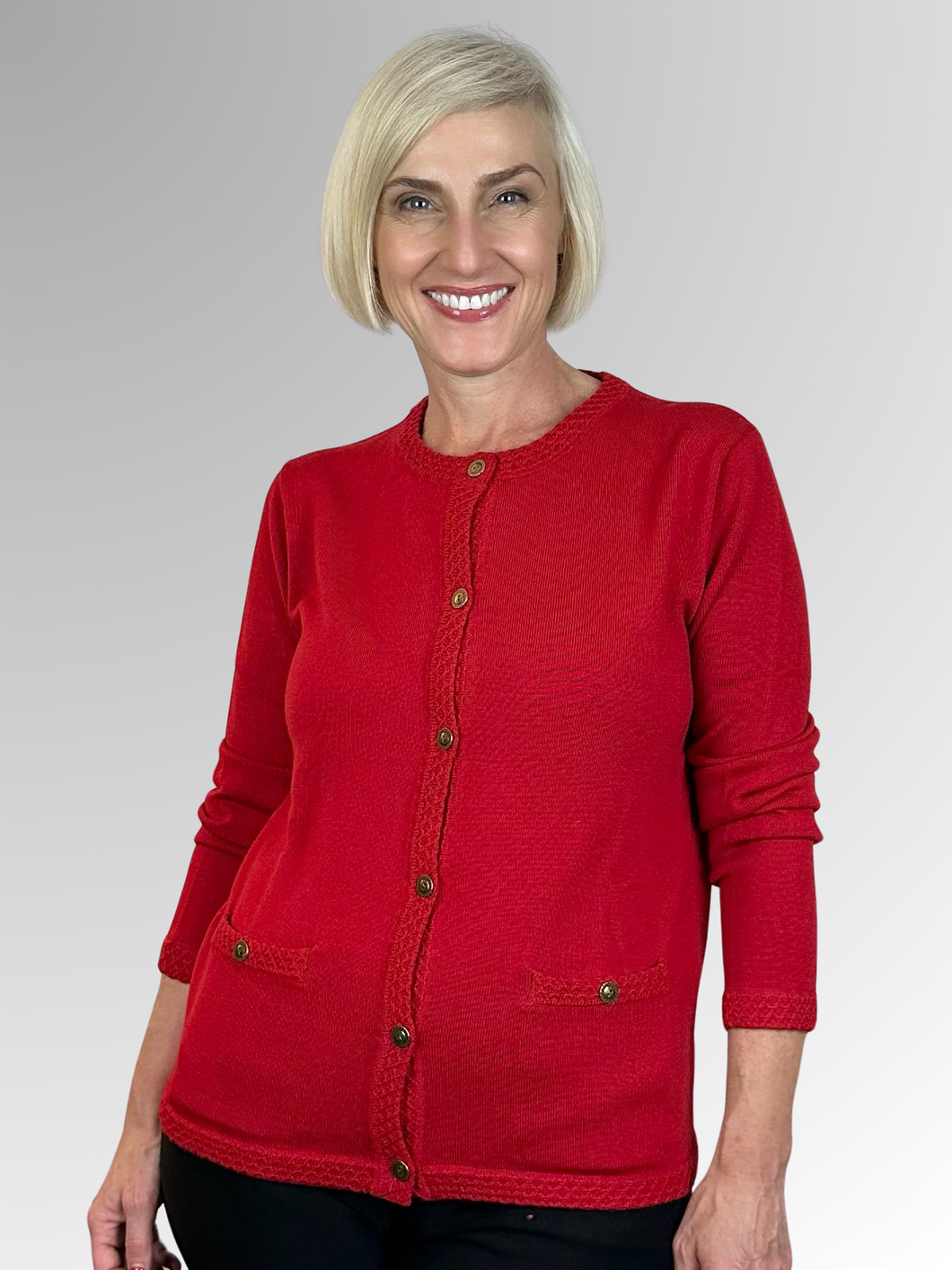 For over seventy years, Slade Knitwear has been a distinguished Australian brand known for its superior women's knitwear. This classic Cherry Red Pure Wool Cardigan with honeycomb trim features two pockets and is a must-have for your winter wardrobe. Trust Slade for all your knitwear needs.