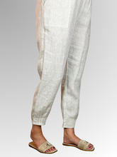 Elevate your warm-weather wardrobe with the Ankle Tuck Linen Resort Pant in Natural, the ultimate choice for effortless summer style. Perfectly balancing a trendy silhouette with everyday practicality, these pants are crafted from premium, breathable linen designed to keep you cool and comfortable all day long.