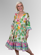 The Andrea Layered Dress by Escape is a beautiful celebration of easy-wear style. Crafted from breathable, lightweight rayon, this midi-length dress features a vibrant tropical botanical print with lush palm trees, exotic hibiscus, and hidden safari animal motifs over a soft cream base, beautifully anchored by a bold border patterned hem. With its soft, fluid texture, it’s the ultimate throw-on-and-go piece that drapes effortlessly over the body.