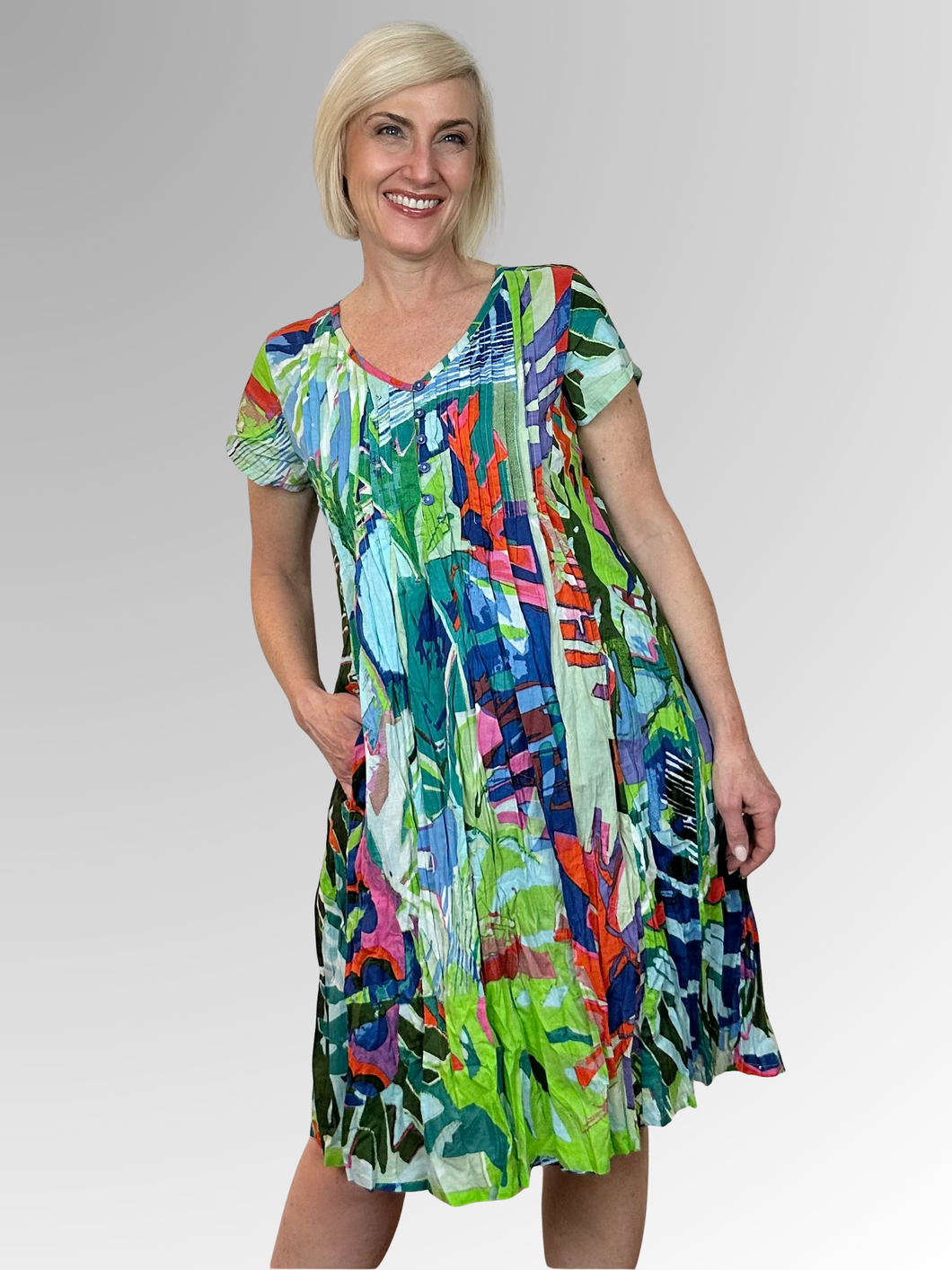 Stay cool and comfortable in the Tower Blue Easy Fit Dress by Orientique. Made from organic crinkled cotton, this dress is lightweight and perfect for those hot summer days. The relaxed fit, V-neckline with button trim and pleat detailing add a touch of style, while the pockets make it practical for everyday wear. Ideal for lounging in the heat!