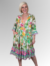 The Andrea Layered Dress by Escape is a beautiful celebration of easy-wear style. Crafted from breathable, lightweight rayon, this midi-length dress features a vibrant tropical botanical print with lush palm trees, exotic hibiscus, and hidden safari animal motifs over a soft cream base, beautifully anchored by a bold border patterned hem. With its soft, fluid texture, it’s the ultimate throw-on-and-go piece that drapes effortlessly over the body.
