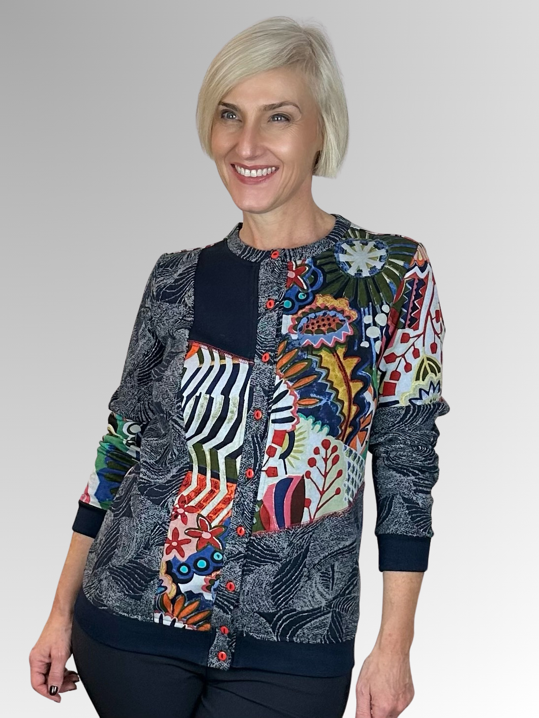 The Hotel California Cardi Top by Orientique is a fun and modern addition to any wardrobe. Its spliced design offers versatility, allowing you to wear it open with a plain top underneath or buttoned up for a more polished look. Made with a navy base colour and crafted from rayon, cotton and spandex, this top is both comfortable and stylish. A must-have for any fashion-forward individual!