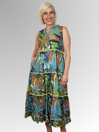 The Tayrona Sleeveless Tassel Dress is your ticket to carefree summer fun. This lightweight midi features a relaxed silhouette, tasseled ties, a finely ruffled hem and a sleeveless design that keeps you cool and comfy all day long. Made from 100% organic cotton, it's the perfect companion for beach getaways, seaside strolls, and those golden-hour moments. Slip it on and embrace effortless style with a playful twist.