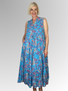 The Kea Sleeveless Tassel Dress by Orientique is crafted from organic crinkle cotton for comfort and breathability. The dress features a feminine floral design, tasseled ties at the neckline, plus two side pockets for added convenience. Enjoy cool and comfortable days in style!