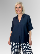 Discover the perfect balance of casual ease and elevated style. The Navy Del Mar Top is a beautifully understated piece designed to be an indispensable favourite in your everyday wardrobe. Featuring a flattering V-neckline complemented by a soft collar, this easy-to-wear top brings a polished, structured touch to a fluid silhouette that keeps you looking put-together with zero effort.