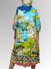 Step into summer with flair and comfort in the Amalfi Button Through Collared Dress by Orientique! This breezy dress, made from soft organic crinkled cotton, showcases a delightful Italian Riviera print, 3/4 sleeves, a crisp collar, and a button-through front. Whether you're relaxing at home or exploring the town, the Amalfi adds a splash of fun and effortless style to your day.