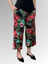 Bring a fresh, playful energy to your style with the Calypso 7/8 Pant by Philosophy. Showcasing a striking red, black, and green tropical print, these wide-leg pants combine a modern silhouette with effortless elegance. Featuring a comfortable pull-on elastic waistband and practical side pockets, they are perfectly cropped at a stylish 7/8 length. Crafted from a smooth, easy-care polyester-elastane blend, they deliver a flawless fit and fuss-free maintenance from day to night.