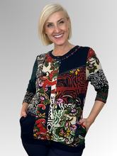 The Zapotec Cardi Top by Orientique is a fun and modern addition to any wardrobe. Its spliced design offers versatility, allowing you to wear it open with a plain top underneath or buttoned up for a more polished look. Made with a navy base colour and crafted from rayon and spandex, this top is both comfortable and stylish. A must-have for any fashion-forward individual!
