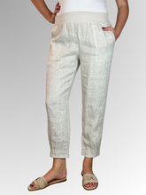 Elevate your warm-weather wardrobe with the Ankle Tuck Linen Resort Pant in Natural, the ultimate choice for effortless summer style. Perfectly balancing a trendy silhouette with everyday practicality, these pants are crafted from premium, breathable linen designed to keep you cool and comfortable all day long.