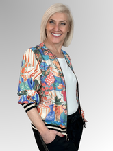 Bring playful style to your wardrobe with Orientique’s Picnic Digital Print Zip Jacket. Crafted from lightweight rayon with a luxurious satin finish, it offers effortless comfort in a relaxed bomber silhouette. The striking digital print is perfectly elevated by eye-catching black and gold lurex bands at the cuffs and hem. Complete with a breezy zip front, it is the perfect fashion-forward layer to easily elevate any everyday outfit.