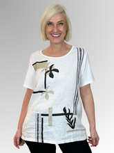 The White Bay Leaf Top features a modern botanical print combined with a comfortable relaxed fit, making it a striking, contemporary piece designed to bring a fresh energy to everyday dressing. Built around a thoughtful dual-fabric design, the top beautifully pairs a polished front panel with a relaxed, breathable back.