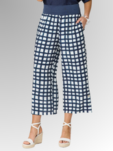 Step into the season with a bold, refreshing look. The Monaco Geometric Pant is a standout statement piece for warm-weather dressing, beautifully combining a crisp navy and white grid print with a relaxed, effortless silhouette. Designed for the modern woman who loves eye-catching style without compromising on ease, these pants are bound to become your new seasonal favourite. 