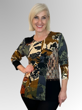 Elevate your everyday style with the Orientique Dagomba Patch Top - a rich tapestry of colour and texture. This playful piece combines mixed fabrics in a spliced design, creating visual interest from every angle. Detailed button trim and decorative stitching add character and charm, while the soft rayon and spandex blend ensures comfort and movement. Perfect for those who love bold, artistic fashion that stands out.