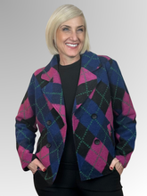 Make a statement in our Argyle Double-Breasted Jacket. Showcasing a bold argyle design in black, pink, navy, and green, this standout piece brings a modern twist to a timeless silhouette. Crafted from a premium wool blend, it offers both warmth and comfort without compromising on style. Designed with a classic collar, functional pockets, and a flattering slightly cropped length, this versatile jacket moves effortlessly from weekday wear to relaxed weekend styling. Pair it with tailored trousers for a refine