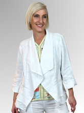 The White Peplum Jacket by Maglia is your perfect summer companion. Made from breathable linen, it features a stylish waterfall collar and a layered peplum for shape. With charming raw edging and fold-back 3/4-length sleeves, this versatile piece transitions effortlessly from workdays to weekend adventures. Light, playful, and effortlessly chic!