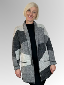 Upgrade your wardrobe this autumn/winter with the Astrid Knit Jacket by Jillian. Crafted from a blend of acrylic, nylon, and polyester, this soft and cosy jacket is perfect for cooler days. Its longline, oversized design offers a relaxed fit, a fold back collar and cuffs as well as pockets for added convenience. The geometric ash and charcoal design makes it versatile enough to pair with solid black or add a pop of colour for a statement look.
