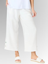 Meet your new wardrobe foundation. The Essential Button Pant in ivory is meticulously crafted for the modern woman who refuses to sacrifice comfort for style. Whether you are running weekend errands or dressing up for a casual evening out, these pants deliver a beautifully polished look. Designed with a relaxed, wide-leg silhouette and a chic cropped length, this piece offers a breezy, fashion-forward cut that moves beautifully with you.