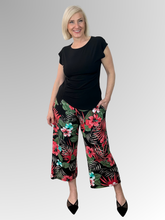 Bring a fresh, playful energy to your style with the Calypso 7/8 Pant by Philosophy. Showcasing a striking red, black, and green tropical print, these wide-leg pants combine a modern silhouette with effortless elegance. Featuring a comfortable pull-on elastic waistband and practical side pockets, they are perfectly cropped at a stylish 7/8 length. Crafted from a smooth, easy-care polyester-elastane blend, they deliver a flawless fit and fuss-free maintenance from day to night.