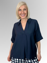 Discover the perfect balance of casual ease and elevated style. The Navy Del Mar Top is a beautifully understated piece designed to be an indispensable favourite in your everyday wardrobe. Featuring a flattering V-neckline complemented by a soft collar, this easy-to-wear top brings a polished, structured touch to a fluid silhouette that keeps you looking put-together with zero effort.