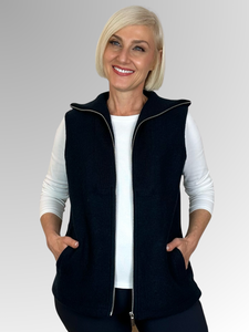 Our Navy Zip Front Vest is expertly crafted from boiled wool and showcases the "Woolmark" label, known for its exceptional quality and high standards. Featuring a ribbed collar and practical pockets, this versatile piece is perfect for winter layering while offering both warmth and style.