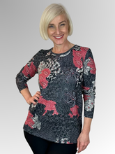 Keep cozy and chic with our Coral Long Sleeve Leaf Top. This top boasts a classic cut and is made from a warm blend of polyester and elastane. The vibrant hues and elegant print add a timeless touch to any outfit. Don't wait too long to snag a matching scarf as a bonus with purchase - only while supplies last!