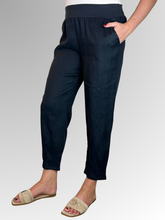 Elevate your warm-weather wardrobe with the Ankle Tuck Linen Resort Pant in Navy, the ultimate choice for effortless summer style. Perfectly balancing a trendy silhouette with everyday practicality, these pants are crafted from premium, breathable linen designed to keep you cool and comfortable all day long.