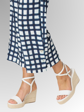 Step into the season with a bold, refreshing look. The Monaco Geometric Pant is a standout statement piece for warm-weather dressing, beautifully combining a crisp navy and white grid print with a relaxed, effortless silhouette. Designed for the modern woman who loves eye-catching style without compromising on ease, these pants are bound to become your new seasonal favourite. 