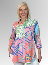 Bring a gentle splash of colour and personality to your seasonal wardrobe. The Urban Jungle Print Overshirt is a statement piece designed to instantly elevate your everyday style. Featuring a muted tropical print in a subtle palette of soft pink, green, coral, and blue tones, this shirt combines beautiful visual texture with a relaxed aesthetic that feels perfect for the season.