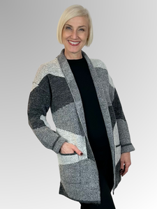 Upgrade your wardrobe this autumn/winter with the Astrid Knit Jacket by Jillian. Crafted from a blend of acrylic, nylon, and polyester, this soft and cosy jacket is perfect for cooler days. Its longline, oversized design offers a relaxed fit, a fold back collar and cuffs as well as pockets for added convenience. The geometric ash and charcoal design makes it versatile enough to pair with solid black or add a pop of colour for a statement look.
