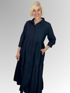 A timeless shirtdress from Orientique's Summer Essential collection crafted with 100% Organic Cotton Poplin. With a classic dark navy hue, this piece features a button-through front, collar, and 3/4 length sleeves with fold-back tabs, for a chic, comfortable look that will stay on-trend all season long. Elevate with colourful beading for a unique finish.