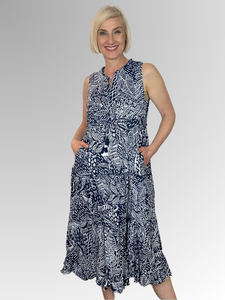 The Orientique Leros Sleeveless Tassel Dress in navy and white is a stylish choice for the warmer weather. Crafted from 100% organic cotton, this dress is lightweight, breathable and comfortable. Featuring tasseled ties, pockets, fine gathering on each layer and a ruffled hemline for a feminine look. Enjoy this beautiful design for a look that stands out.