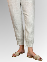 Elevate your warm-weather wardrobe with the Ankle Tuck Linen Resort Pant in Natural, the ultimate choice for effortless summer style. Perfectly balancing a trendy silhouette with everyday practicality, these pants are crafted from premium, breathable linen designed to keep you cool and comfortable all day long.