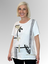 The White Bay Leaf Top features a modern botanical print combined with a comfortable relaxed fit, making it a striking, contemporary piece designed to bring a fresh energy to everyday dressing. Built around a thoughtful dual-fabric design, the top beautifully pairs a polished front panel with a relaxed, breathable back.