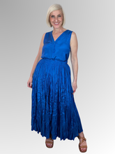 Embrace effortless elegance with the Blue Lux Crinkle Skirt by Escape. Perfectly complementing your warm-weather wardrobe, this maxi-length skirt is crafted from premium, breathable rayon that offers a beautiful, fluid drape and a subtle satin-like luster. It features a signature crinkle texture that provides a naturally low-maintenance finish; perfect for travel and busy days since it requires absolutely no ironing.