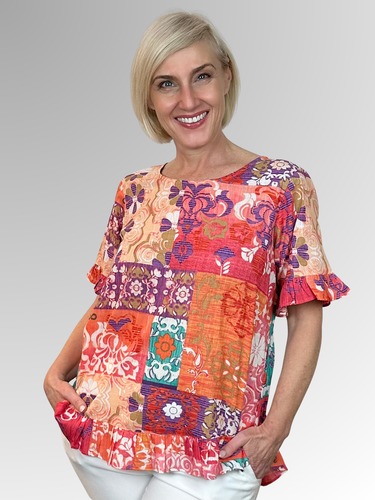 Made from soft organic cotton, the Araya Frill Top by Orientique features a relaxed A-line shape and generous fit for ultimate summer comfort. Playful frills adorn the hem and sleeves with a button-down back for an interesting twist. Hand-painted Persian and Oriental motifs in a beautiful mix of jade, watermelon, and peach bring vibrant, artistic flair to sunny days and warm evenings. This top is your go-to for effortless, breezy style all summer long.